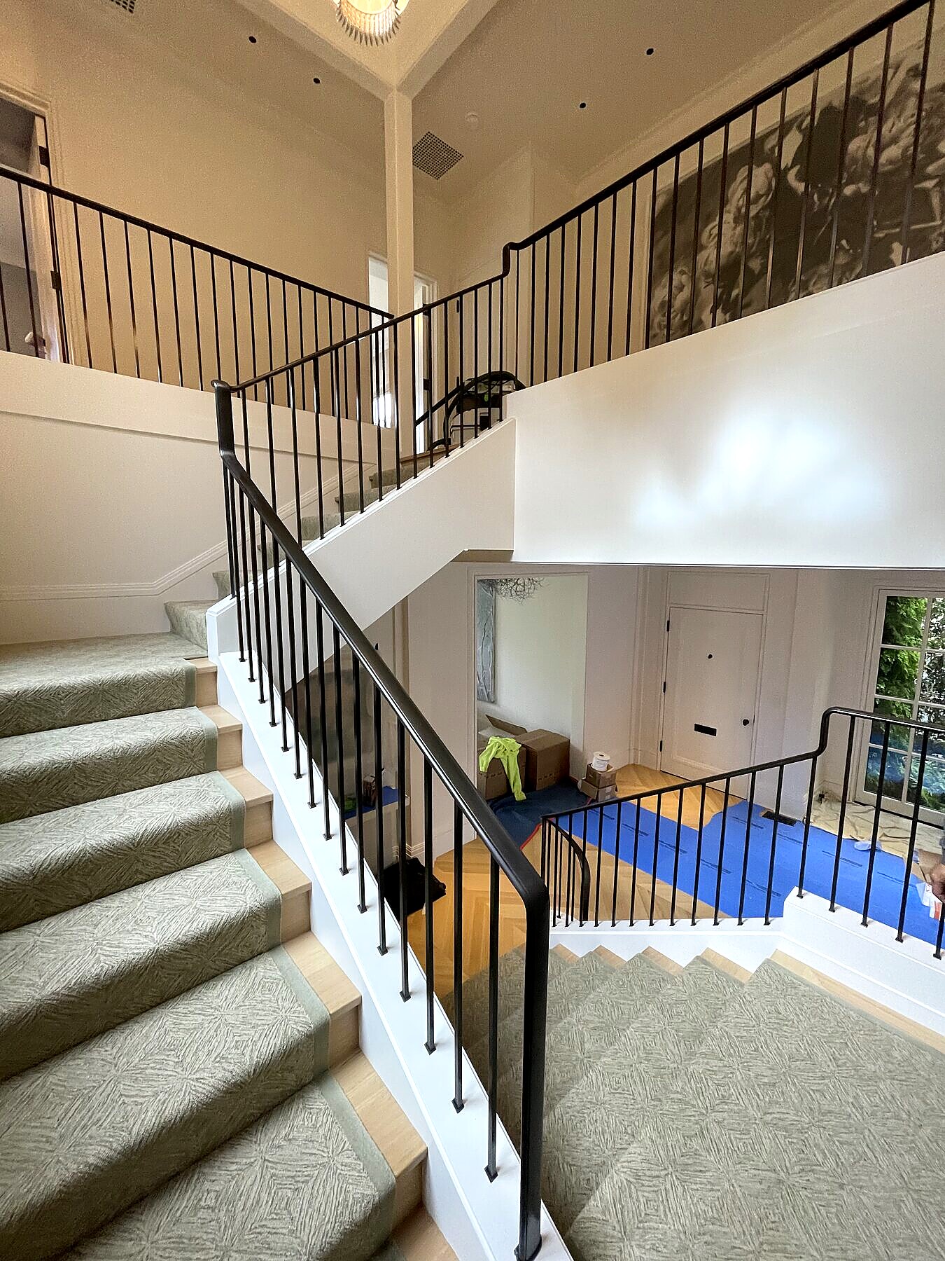 Blackened brass entry stair railing, custom finish