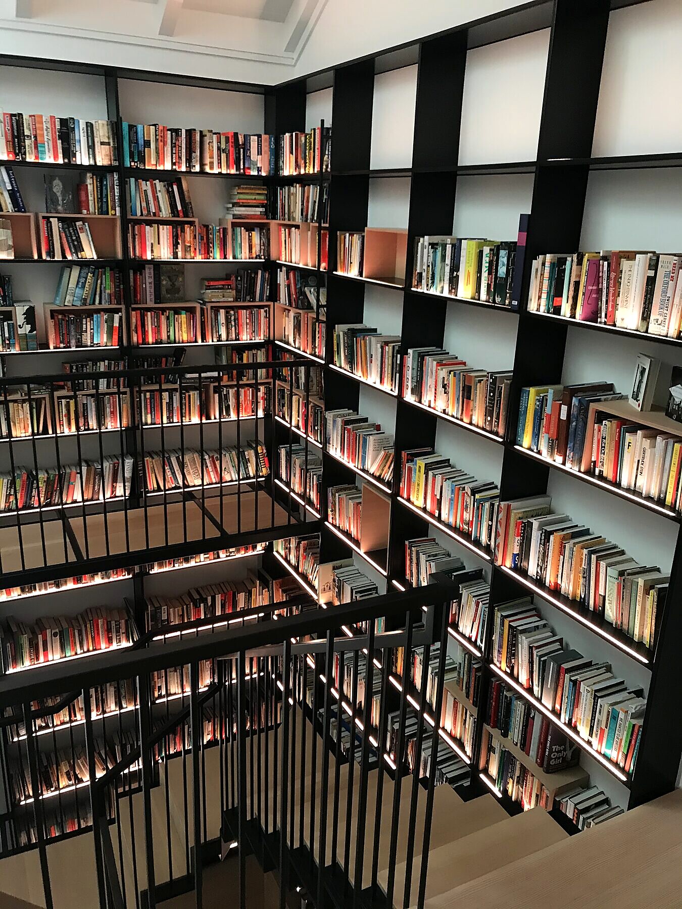 Blackened steel and glass stair railing in a private library, San Diego