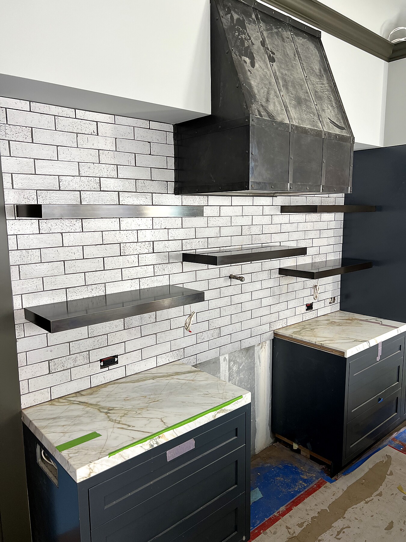Floating blackened steel shelves and custom range hood, kitchen