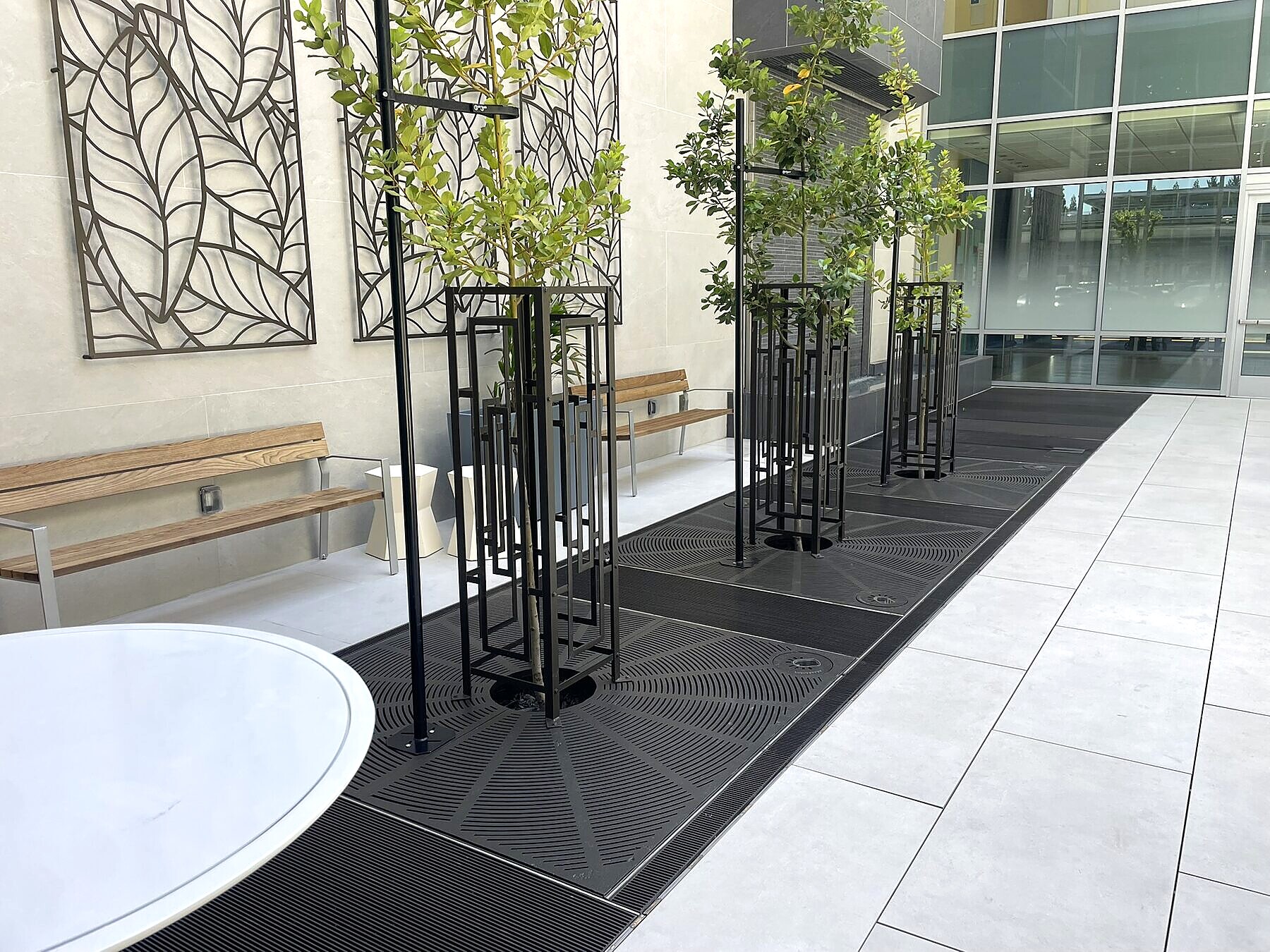Architectural steel courtyard tree grating, commercial installation